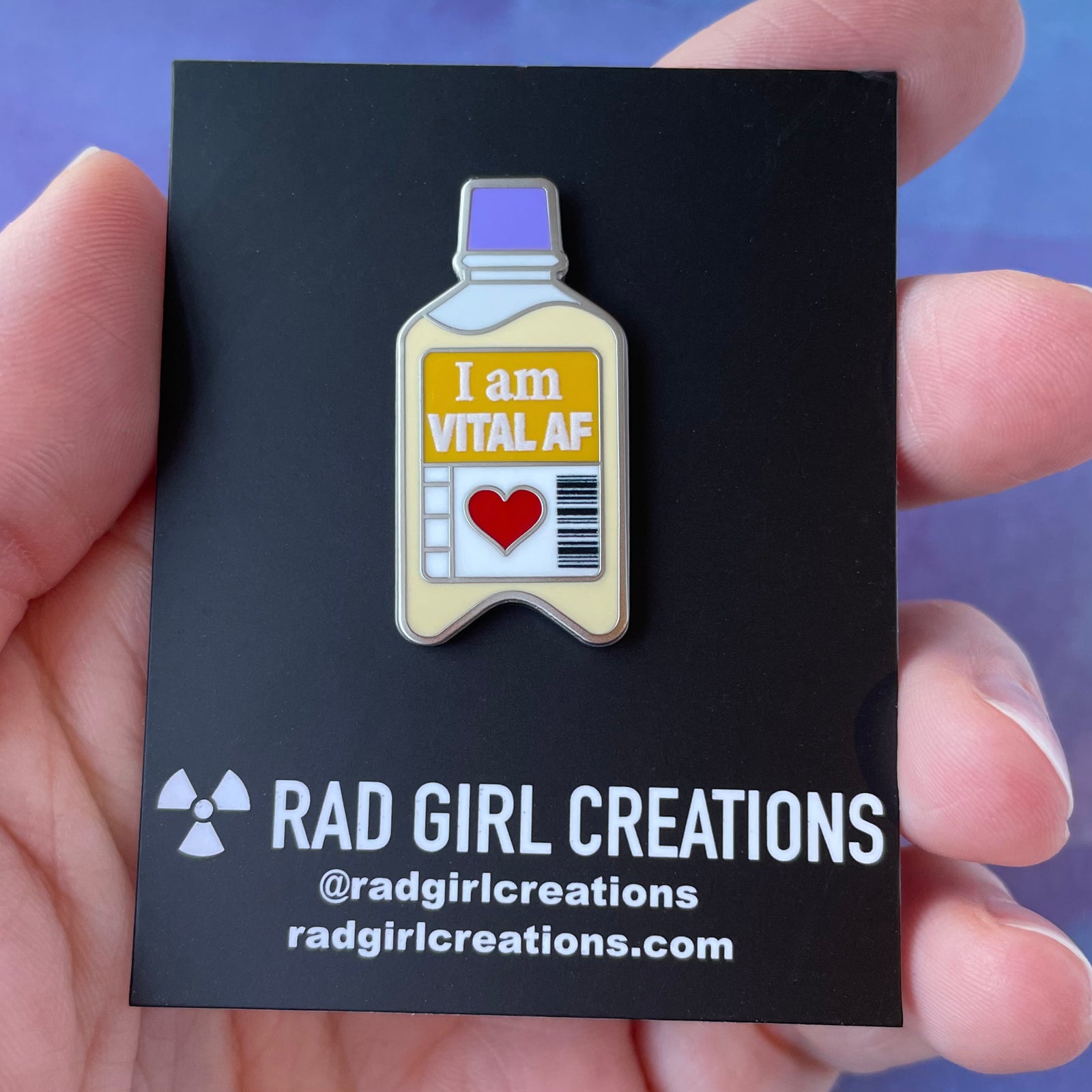 Enamel pin with bottle design and 'I am VITAL AF' text on a purple background