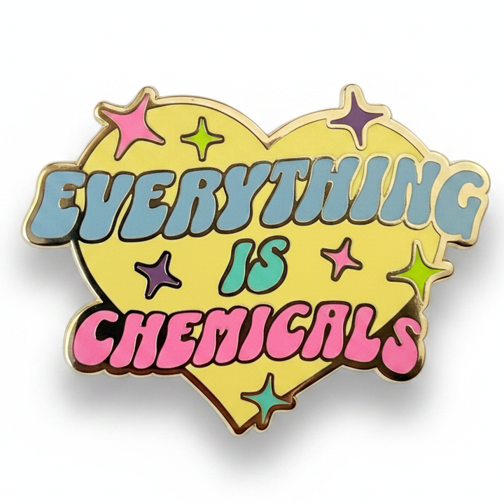 Heart-shaped enamel pin with 'EVERYTHING IS CHEMICALS' text and colorful stars on a white background
