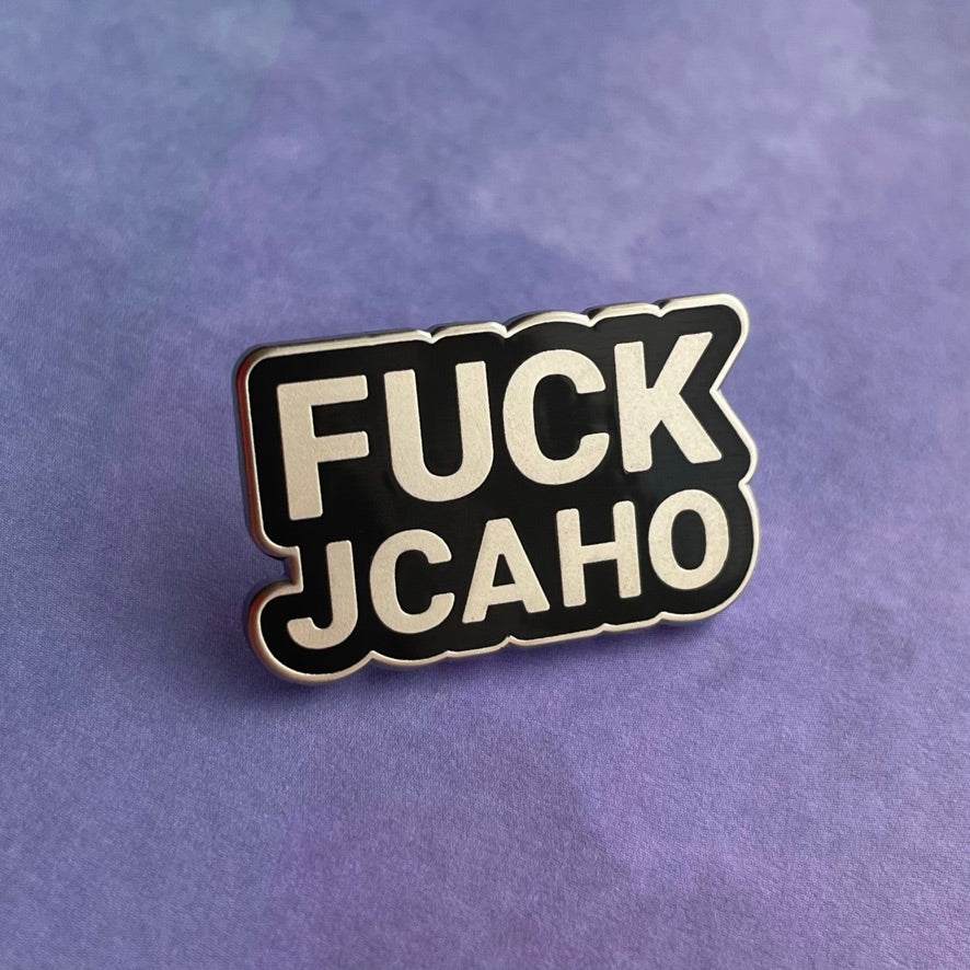 Sticker with 'FUCK JCAHO' text on a gray background