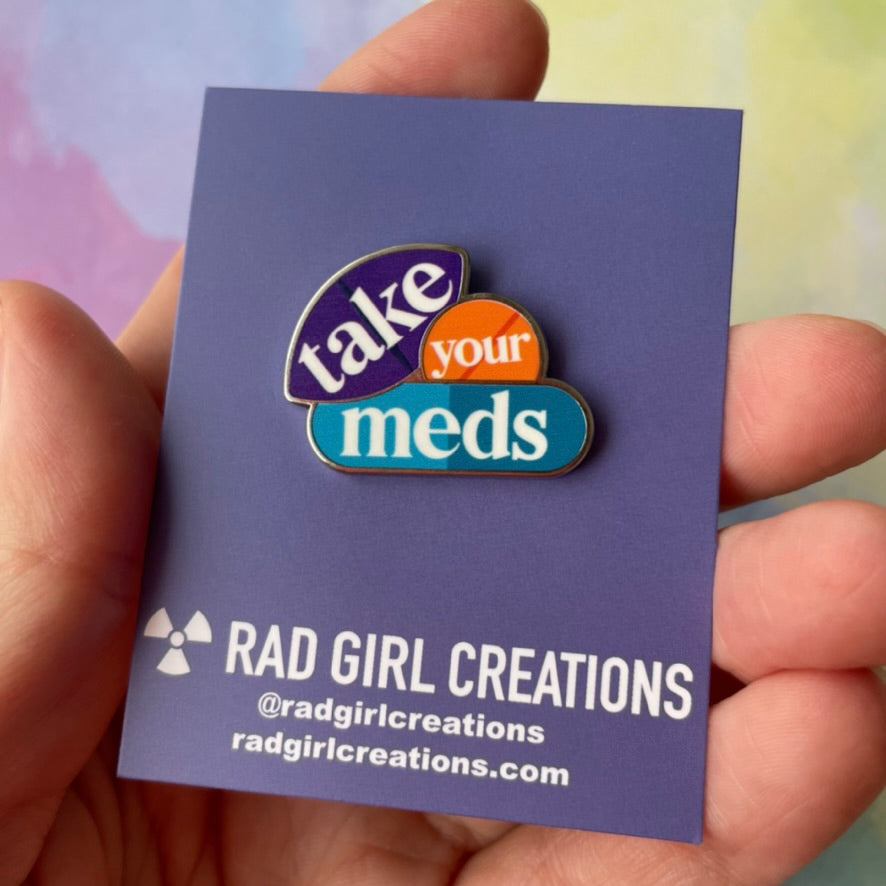 Colorful badge with 'take your meds' text on a gray background