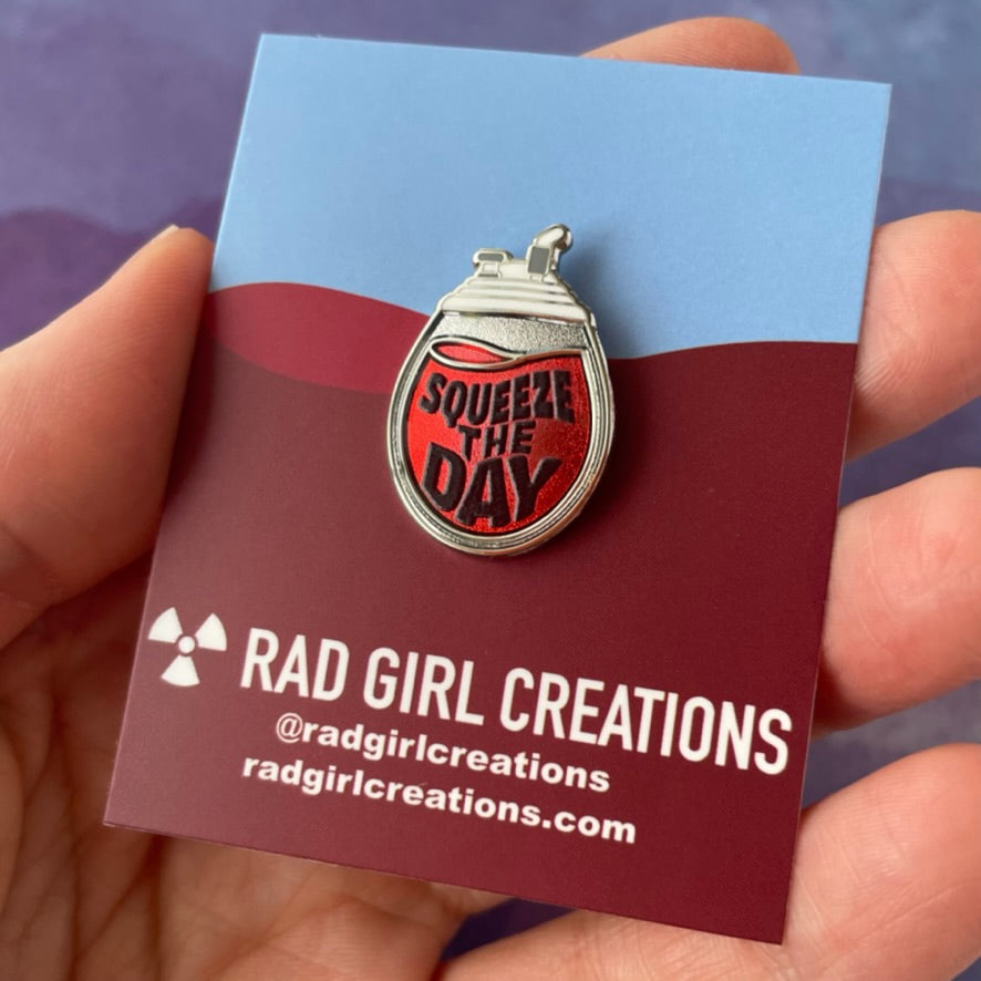 Pendant with 'Squeeze the Day' text on a gray background
