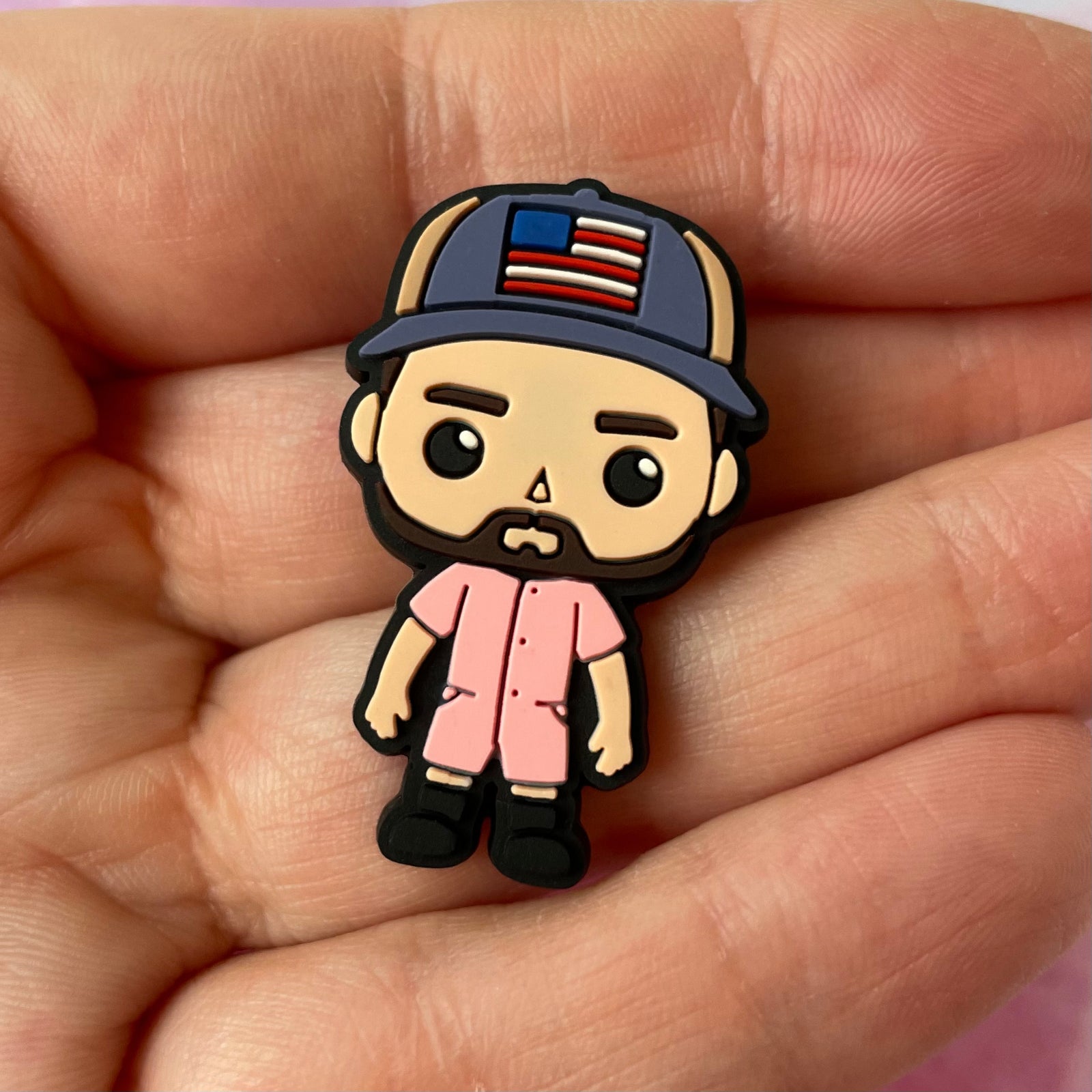 Cartoon character wearing a cap with an American flag on a gray background