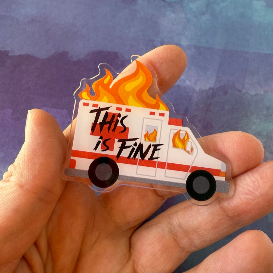 Bagde reel of an ambulance with flames and 'This is Fine' text on a white background
