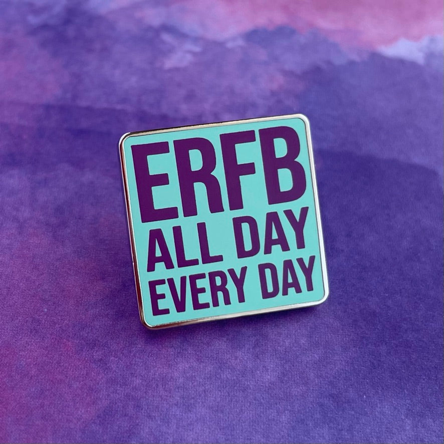 Enamel pin with 'ERFB ALL DAY EVERY DAY' text on a light blue background