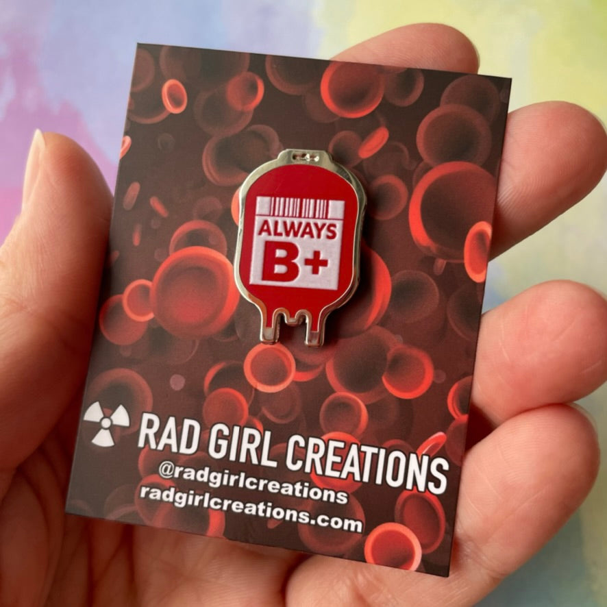 Red blood donation bag with 'Always B+' text on a gray background