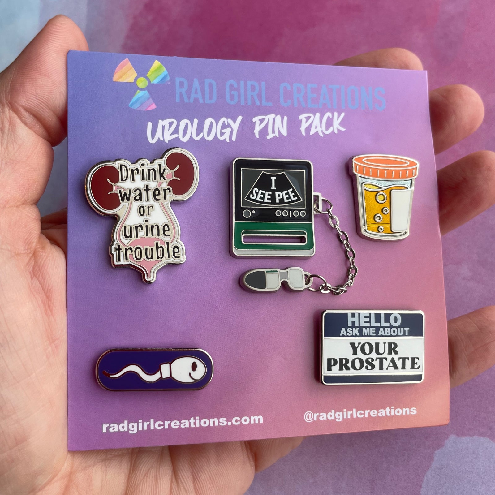 Urology-themed pin pack with humorous designs on a purple card, featuring 'Rad Girl Creations'.